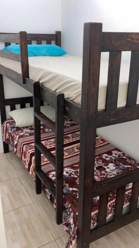 a bunk bed in a room with a rug at Flat WinterVille Residence - Gravatá in Gravatá