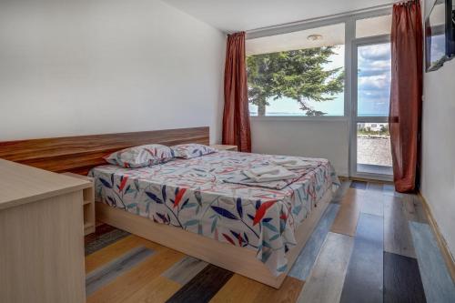 a small bedroom with a bed and a window at Saint George Hotel 2 in Kavarna