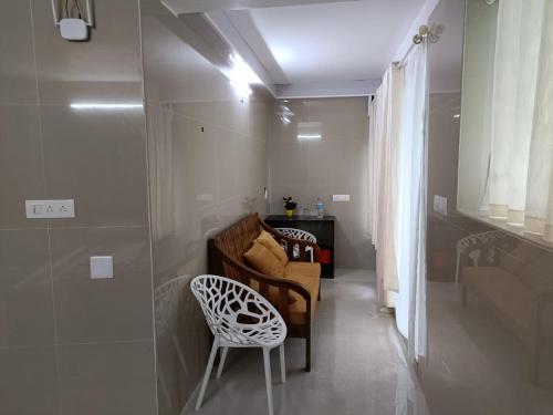 a living room with a chair and a couch at CHILLAX Resorts Palakkayam THATTU in Paithalmala