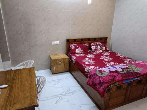 a bedroom with a bed and a table and chairs at CHILLAX Resorts Palakkayam THATTU in Paithalmala