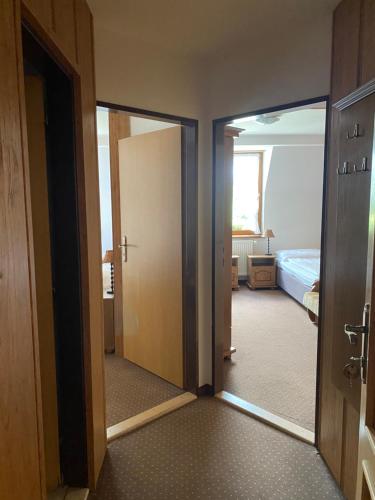 an open door to a room with a bedroom at Penzión Encián in Tatranská Lomnica