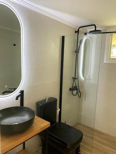 a bathroom with a black sink and a mirror at Dizen Spartochori in Meganisi