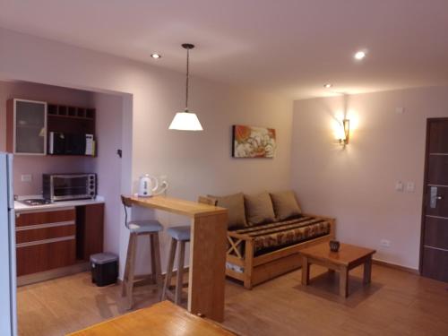 a living room with a couch and a table at Departamento Dina Huapi Bariloche in Dina Huapi