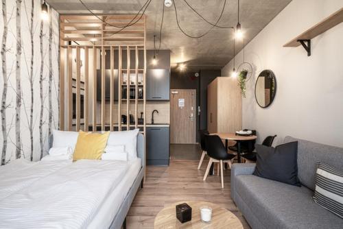a room with a bed and a couch and a table at RentPlanet - Apartamenty Zarembowicza II in Wrocław