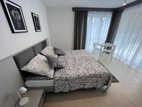 a bedroom with a bed and a couch and a table at Srebrna Perła 2-3 os in Sienna