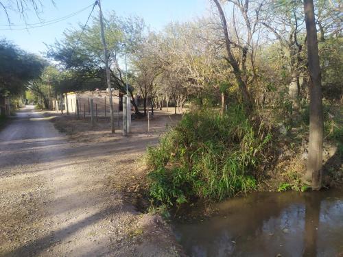 a dirt road with a small body of water at Amoq in Santiago del Estero
