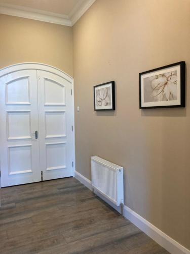 a room with a white door and two pictures on the wall at Highgrange Apartments in Dundalk