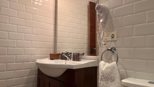 a bathroom with a sink and a shower at Hotel Rural Playa de Aguilar in Muros de Nalón