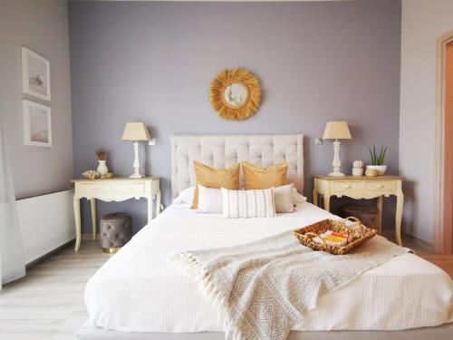 a bedroom with a large white bed with a basket on it at Stylish Apartment close to Kos marina in Kos