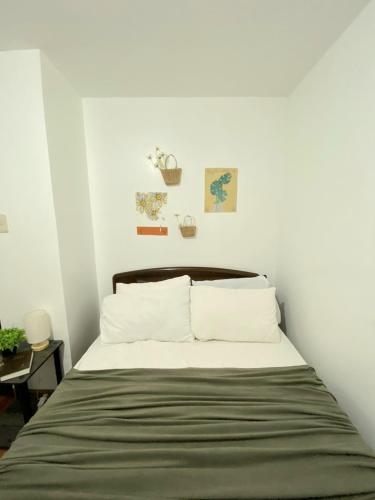 a bedroom with a bed with white walls at RUSTIC THEMED - 2BR TownHouse - near Clark Airport - TRP4 in Mining