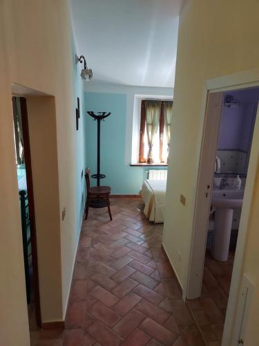 a hallway with a room with a bed and a sink at Il Giovannello in Roccastrada