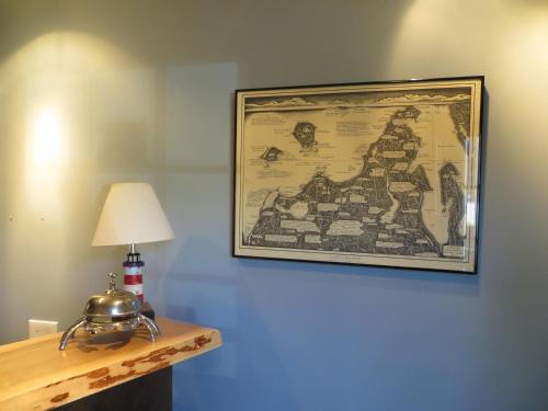 a picture hanging on a wall with a lamp and a table at Empire Lakeshore Inn in Empire