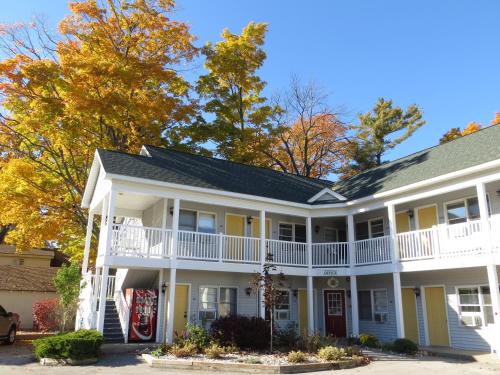 a large white house with a porch at Empire Lakeshore Inn in Empire