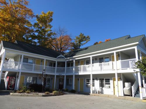 a large white building with white balconies at Empire Lakeshore Inn in Empire