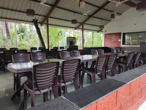 a row of tables and chairs at a restaurant at Cocorico Beach Resort in Dapoli