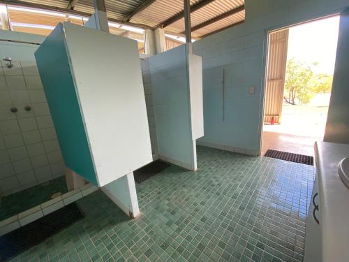 a bathroom with two stalls in a room at Gorge View Bush Retreat : Katherine NT in Katherine