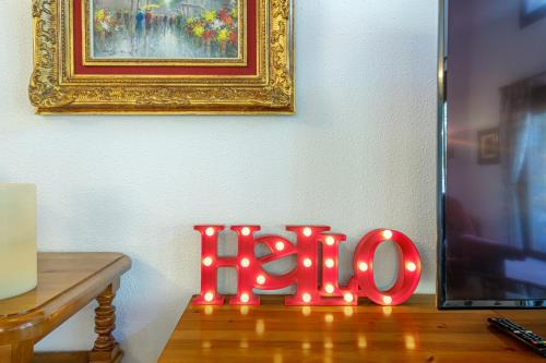 a led sign with lights on top of a wooden floor at Quiet House Sa Calma in Andorra la Vella