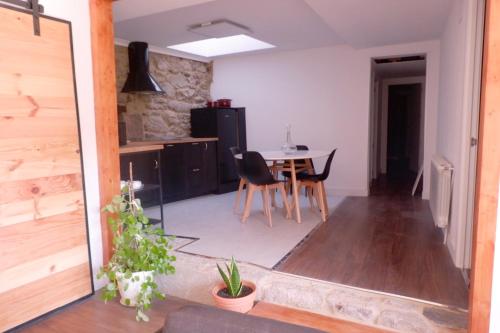 a kitchen and dining room with a table and chairs at A casa da Penela in Sas de Penelas