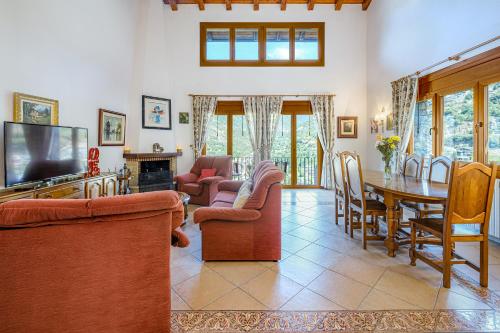 a living room with a table and a dining room at Quiet House Sa Calma in Andorra la Vella