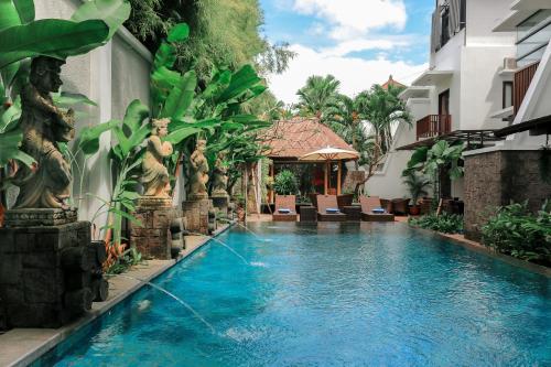 a swimming pool in the middle of a building at Argya Santi Suite and Villas in Seminyak