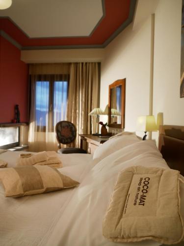 a hotel room with two beds with towels on them at Hotel Rodovoli in Konitsa