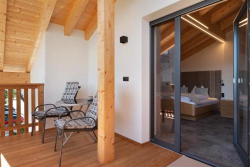 a room with a bed and a table and chairs at Living Lerchna - Schöne Aussicht 2 in Maranza