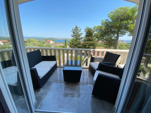a balcony with couches and a coffee table on a porch at Apartments Villa Lora in Kraj