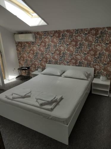 a bed in a room with a brick wall at Casa Jolie in Constanţa