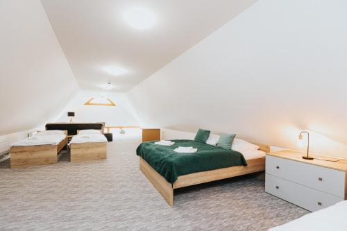 a bedroom with two beds and a piano at Orava Village in Oravská Lesná