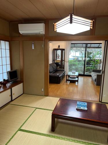 a living room with a couch and a table at japan house shinkoiwa guest house in Tokyo