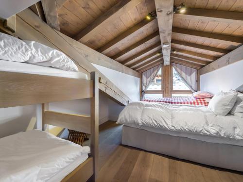 two bunk beds in a room with a wooden ceiling at Chalet Courchevel, 7 pièces, 13 personnes - FR-1-568-1 in Courchevel