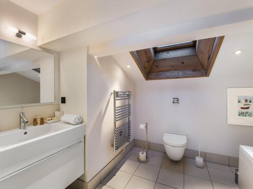 a bathroom with a sink toilet and a mirror at Chalet Courchevel, 7 pièces, 13 personnes - FR-1-568-1 in Courchevel