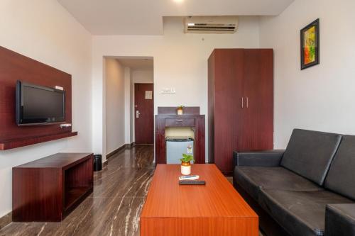 a living room with a couch and a coffee table at Zip By Spree Hotels Mangala Towers Thrissur in Trichūr