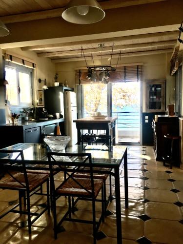 a kitchen with a table and chairs in it at Platamon sea view house in Platamonas