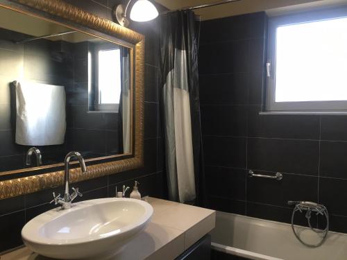 a bathroom with a sink and a mirror at Platamon sea view house in Platamonas