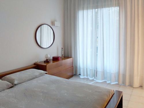 a bedroom with a bed and a large window at Como Sole, green and quiet in Como