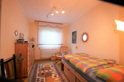 1 dormitorio con 2 camas, vestidor y ventana en Ferienwohnung Zum Rosengarten WEST015 Westerwald, en Driedorf