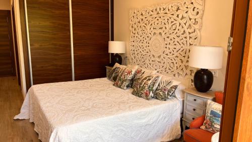 a bedroom with a white bed and a wall at Hotel Rural Playa de Aguilar in Muros de Nalón
