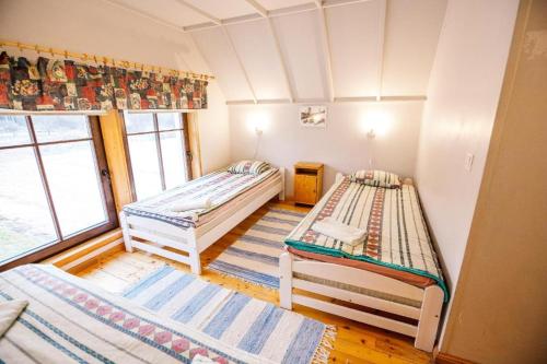 a room with two beds and a window at Reiu Holiday Centre in Paikuse