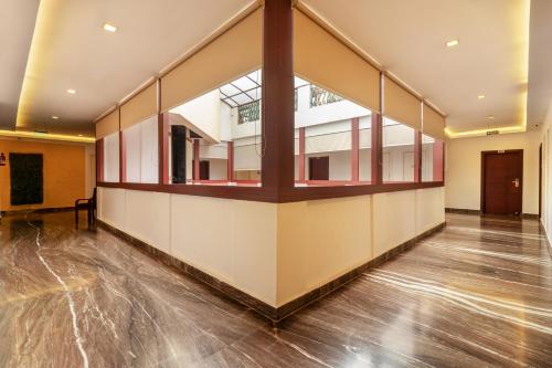 a large empty room with wood floors and a large window at Zip By Spree Hotels Mangala Towers Thrissur in Trichūr
