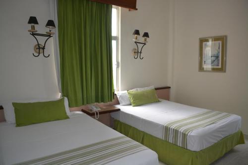 Postel nebo postele na pokoji v ubytování Hotel Ruiz Milán