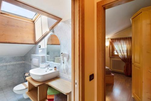 a bathroom with a sink and a mirror at Chalet Letizia Apartments Trilo in Livigno