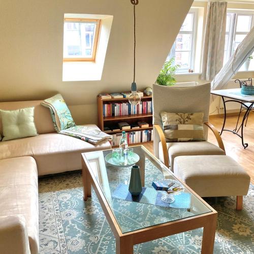 a living room with a couch and a coffee table at Zauberhafte FeWo im Herzen von Wolfenbüttel in Wolfenbüttel