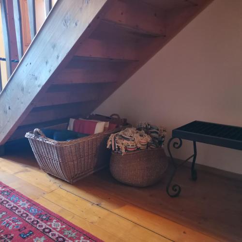 a room with two baskets on the floor next to a staircase at Bodenschmiede in Hopfgarten im Brixental