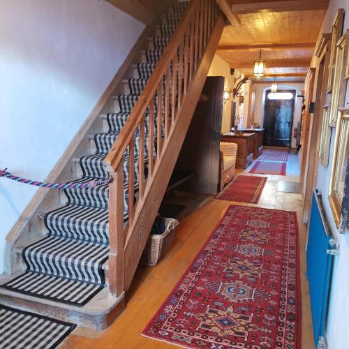 a hallway with a staircase with a rug at Bodenschmiede in Hopfgarten im Brixental