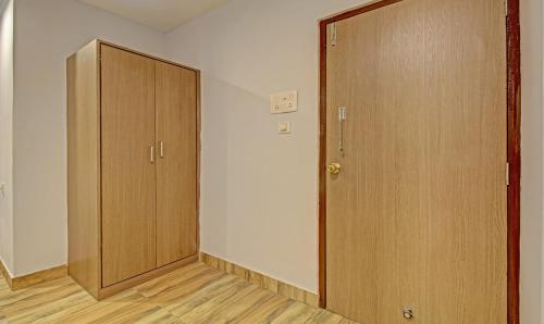 an empty room with a closet and a door at Hotel Royal Crowne near Kolkata Airport in Kolkata