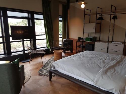 a bedroom with a bed and a tv in it at Hotel V Fizeaustraat in Amsterdam