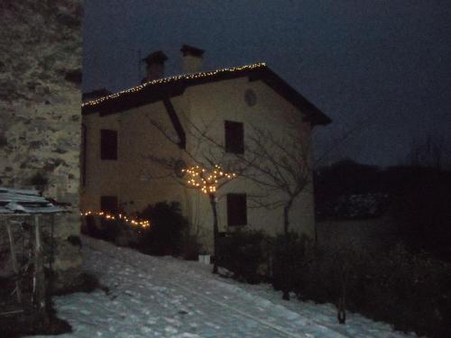 a house with christmas lights on it at night at B&B Casabasoti in Valli del Pasubio