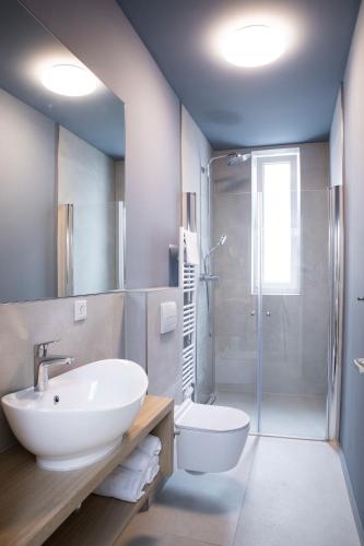 a bathroom with a sink and a toilet and a shower at Villa am Bahnhof in Fulda in Fulda