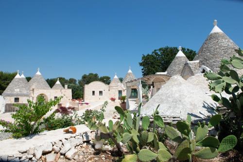 a group of houses with thatched roofs at Trulli Vulés in Ostuni